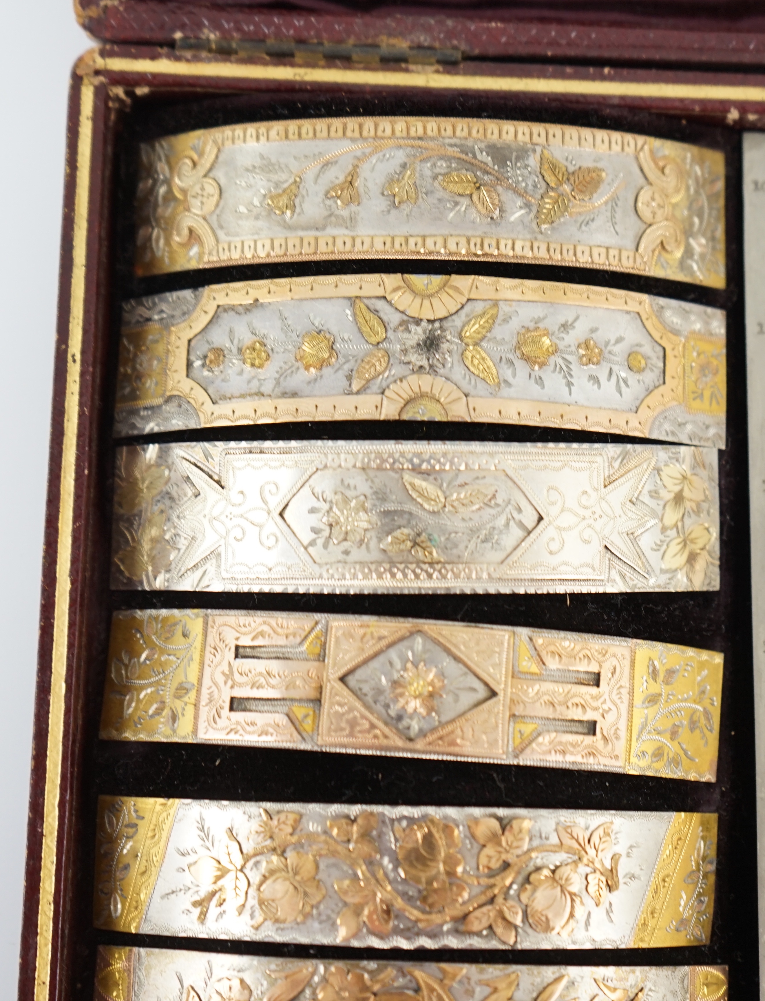 A Victorian cased travelling polychromatic metal bangle template set